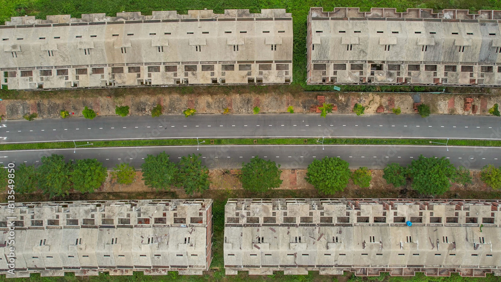 Aerial view of a symmetrical urban street separating two rows of residential buildings, illustrating urban planning and real estate concepts Aerial view of a symmetrical urban street separating two rows of residential buildings, illustrating urban planning and real estate concepts