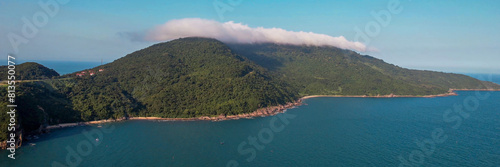 Aerial view of a serene lake by a forest near the coastline, ideal for themes of nature conservation, Earth Day, and outdoor recreation