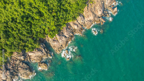 Aerial view of a lush tropical coastline with crystal-clear waters, ideal for travel and environmental concepts, related to summer vacations and World Oceans Day