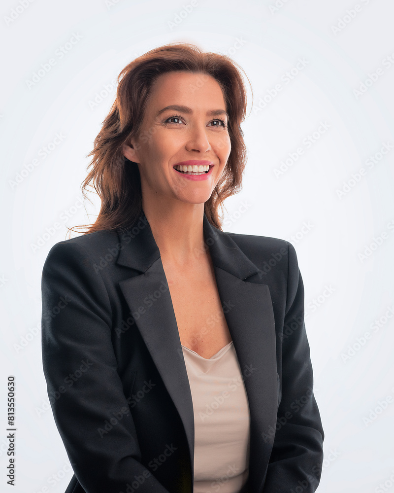 Portrait of brunette haired woman wearing black suit and cheerful smiling against isolated white background Portrait of brunette haired woman wearing black suit and cheerful smiling against isolated white background