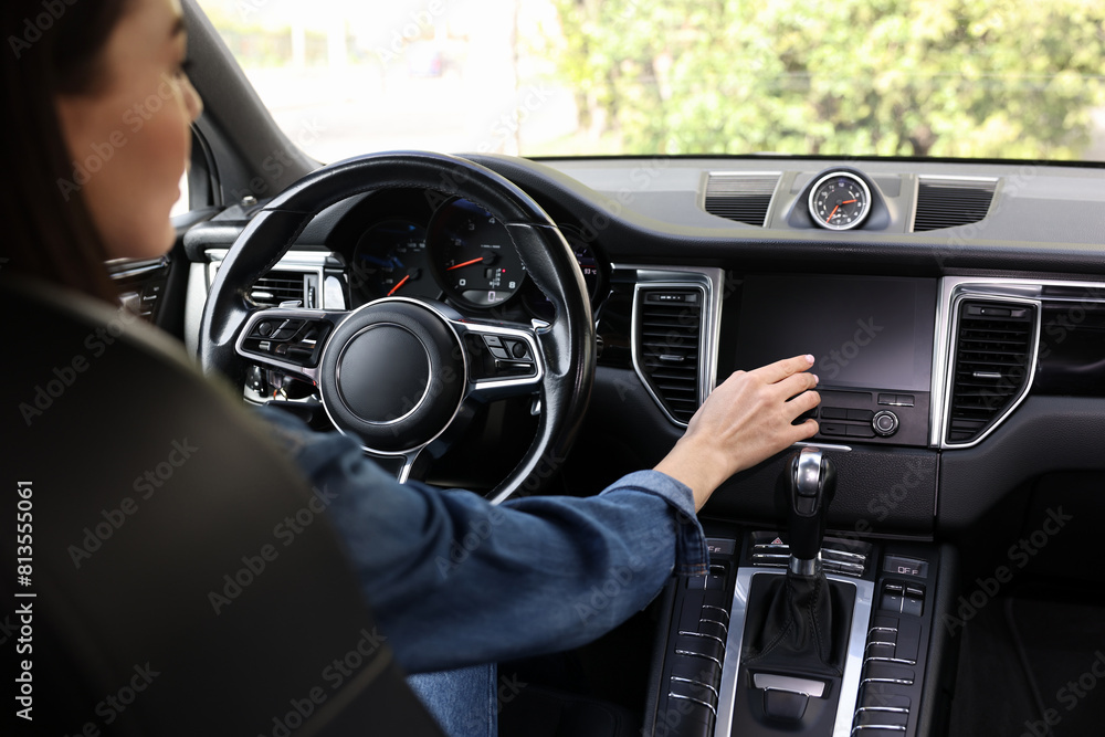Woman using navigation system while driving her car, closeup Woman using navigation system while driving her car, closeup