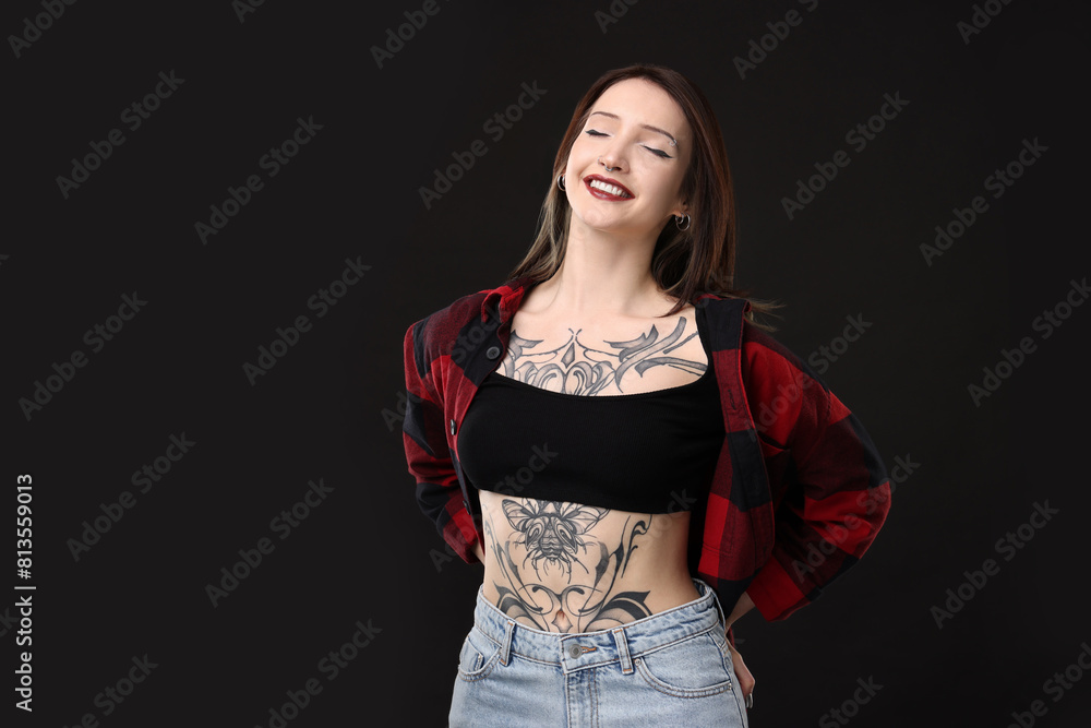 Portrait of smiling tattooed woman on black background. Space for text Portrait of smiling tattooed woman on black background. Space for text
