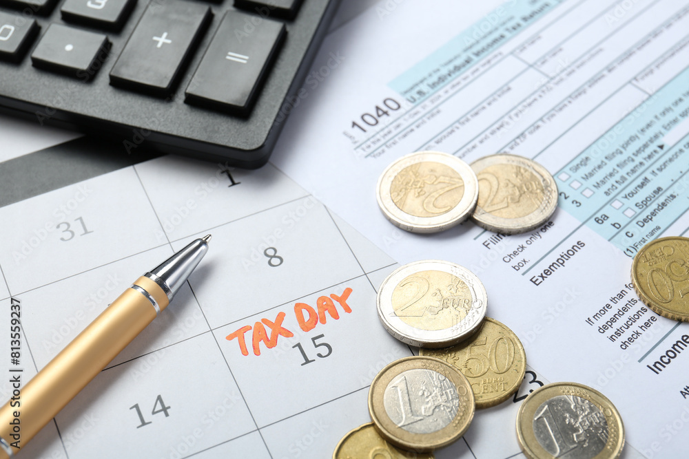 Calendar with date reminder about tax day, documents, coins, pen and calculator, closeup Calendar with date reminder about tax day, documents, coins, pen and calculator, closeup