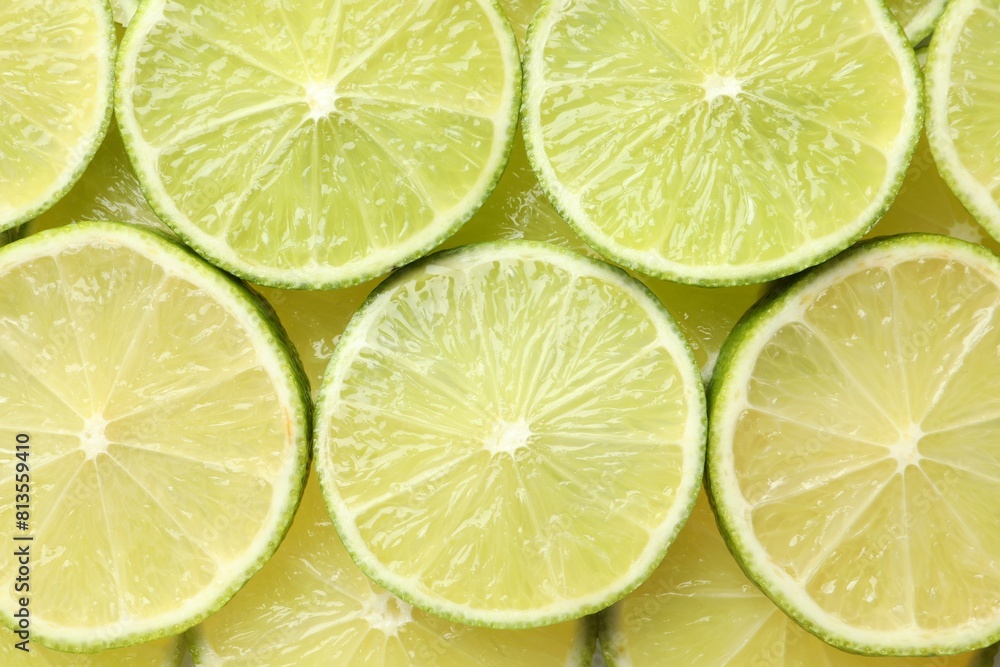 Fresh juicy lime slices as background, top view