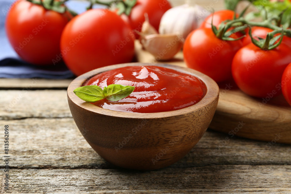 Tasty ketchup, fresh tomatoes, basil and spices on wooden table Tasty ketchup, fresh tomatoes, basil and spices on wooden table