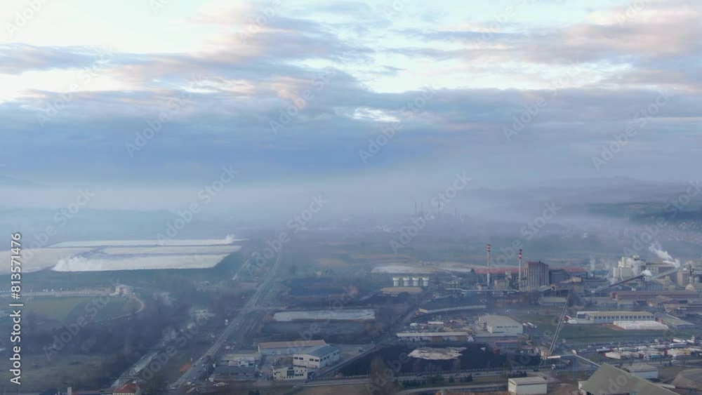 Drone shot of an industrial zone with thick smog and burning fossil fuels Drone shot of an industrial zone with thick smog and burning fossil fuels