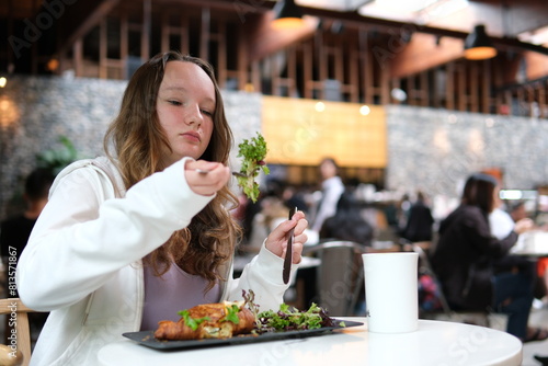 Eating a croissant with salad young attractive woman who eats © Serhii