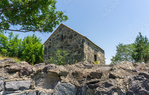 Old church of Partskhisi village. Stone walls around. Bright blue sky