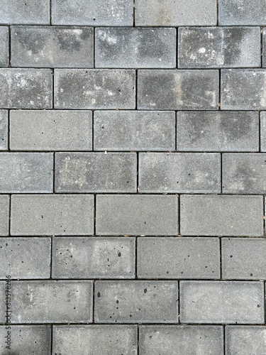 Gray dirty paving stones. Texture of dusty rectangular paving stones