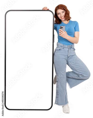 Mobile application advertisement concept image. Full body excited woman leaning big huge phone mock up with empty blank white touch screen. Recommending say check this  out smiling to camera.