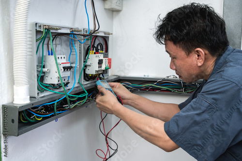 Professional solar engineer installing solar roof combiner box for home use