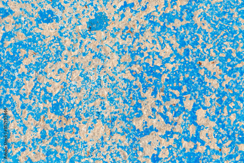 pattern of blue painted old damaged plaster wall with peeling color