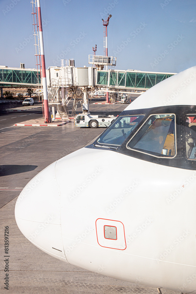 nose of modern jet aircraft in front of the airport terminal nose of modern jet aircraft in front of the airport terminal
