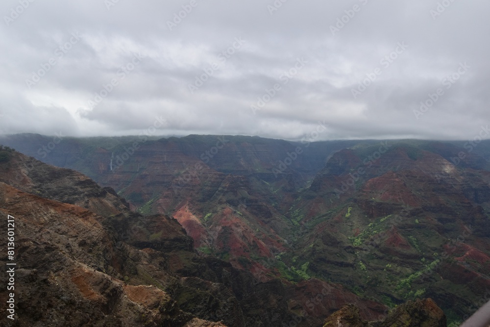 Beautiful view of the Waimea Canyon under a cloudy sky in Hawaii. Beautiful view of the Waimea Canyon under a cloudy sky in Hawaii.