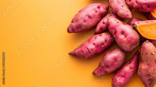 A pile of vibrant orange sweet potatoes photo