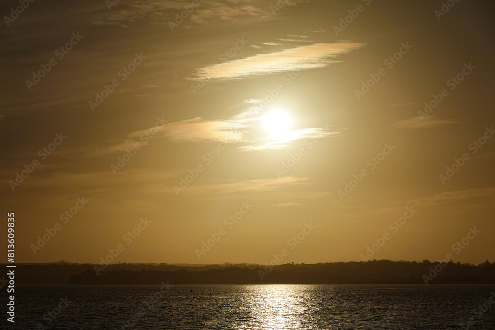 Obraz premium Golden Waters, A serene sunset scene over river, lake, and sea, painting the sky with hues of orange and gold, reflecting nature's beauty