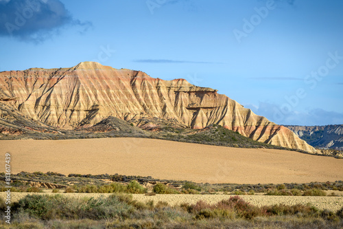 Desert landscape with farmland in front, Bardenas reales national park, Navarro, Spain.