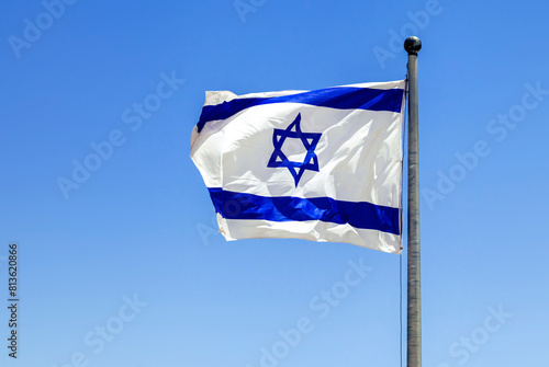 The Israeli flag waving in the bright sunlight