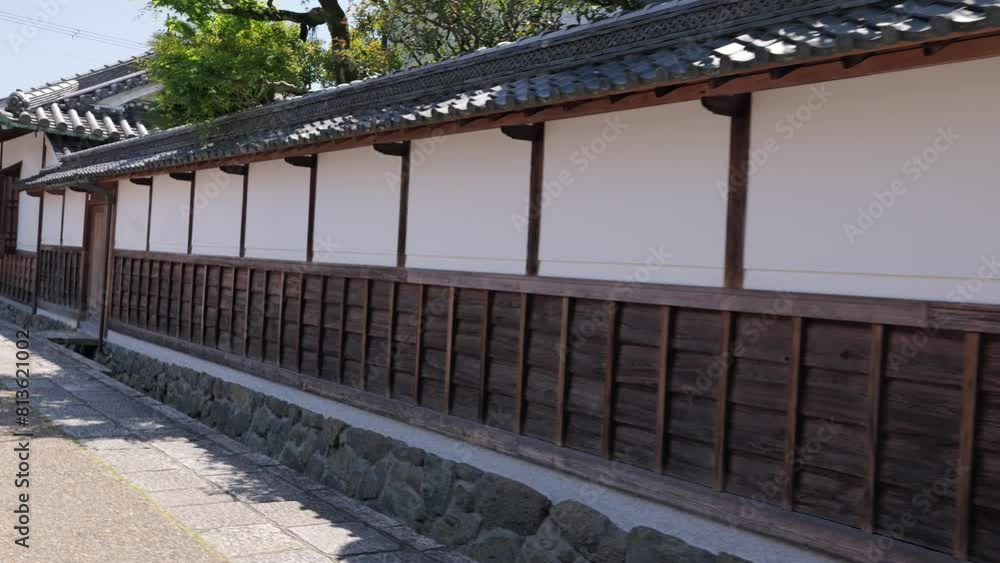 Walking down a street lined with old-fashioned Japanese houses. Walking down a street lined with old-fashioned Japanese houses.