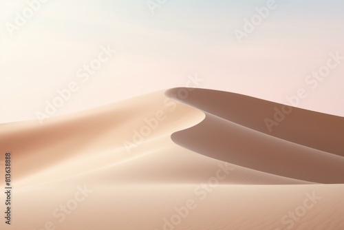 Gentle curves of sand dunes with a soft pink sunrise light creating a tranquil scene