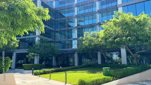 Modern glass office building exterior with reflection in the windows. Bottom up view. Wide angle shot. High quality 4k footage