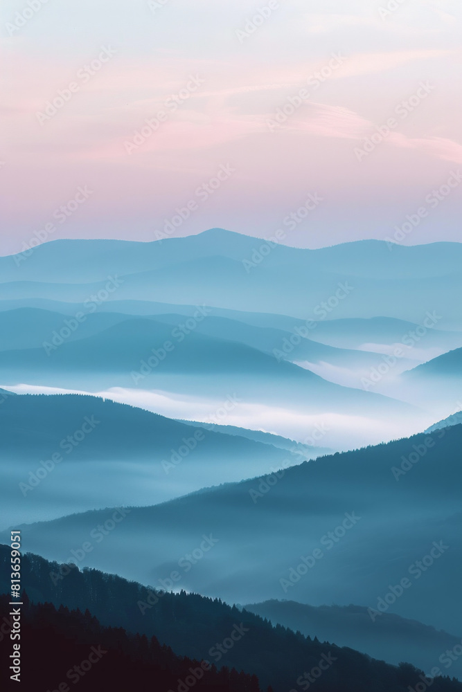 A tranquil view of the layers of mountain ridges disappearing into misty clouds, with their soft outlines and muted colors.