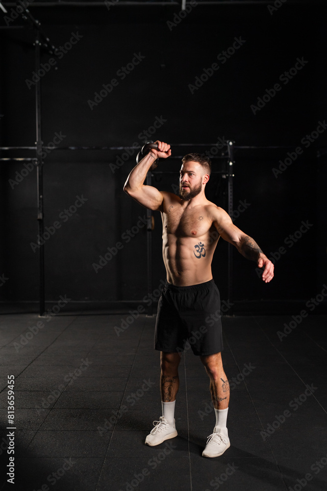 Man lifting a weight with hand, one arm dumbbell snatch, bare chest. Routine workout for physical and mental health. Man lifting a weight with hand, one arm dumbbell snatch, bare chest. Routine workout for physical and mental health.