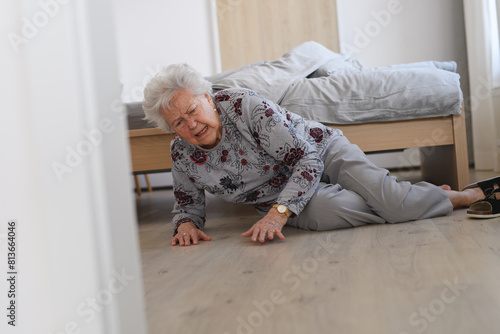 Konstfotografi Elderly woman tripped and fell from bed, injured herself, broke her hip