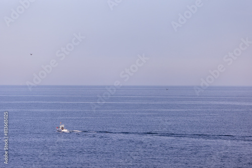 Photo of a boat in the ocean taken in the town of Benidorm in Spain in the ocean on the south Poniente beach
