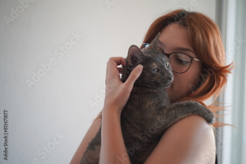 A young woman holding a cat pet portrait