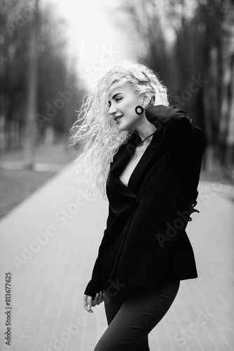 Portrait of a young beautiful blonde girl in a low key outdoors.