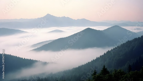 A mountain range covered in thick fog as the sun rises  creating a mystical and serene atmosphere