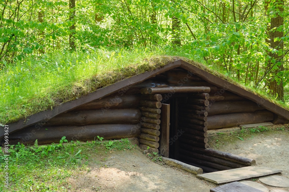Reconstructed dugouts and shelters for soldiers from World War II in the forest. Setting up partisan camps.