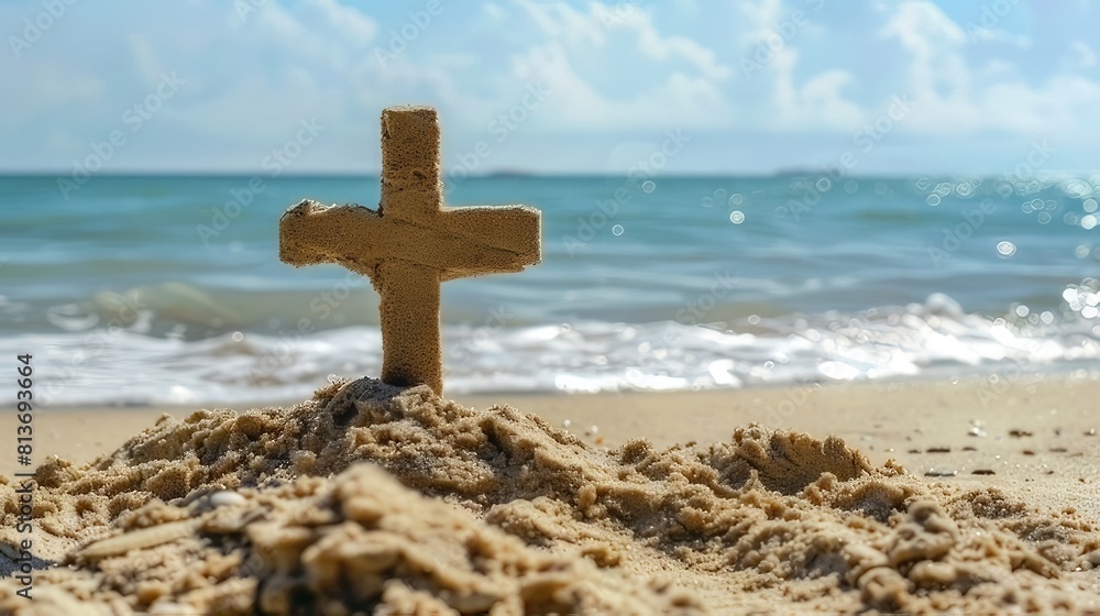 A tranquil Christian cross crafted from sand rests on the seashore, symbolizing peace
