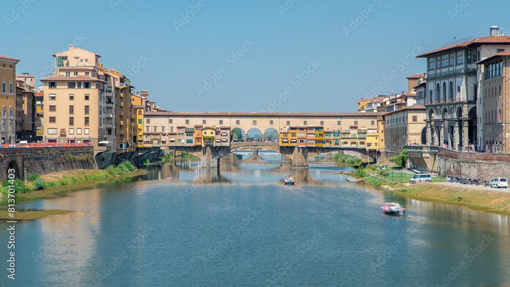 Obraz premium The Ponte Vecchio on a sunny day timelapse, a medieval stone segmental arch bridge over the Arno River in Florence, Italy