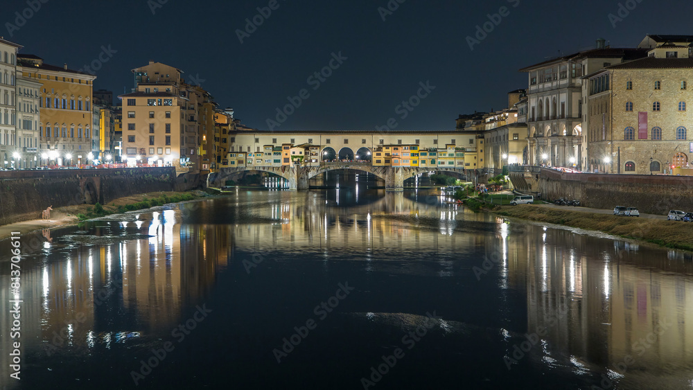 Famous Ponte Vecchio bridge timelapse over the Arno river in Florence, Italy, lit up at night Famous Ponte Vecchio bridge timelapse over the Arno river in Florence, Italy, lit up at night