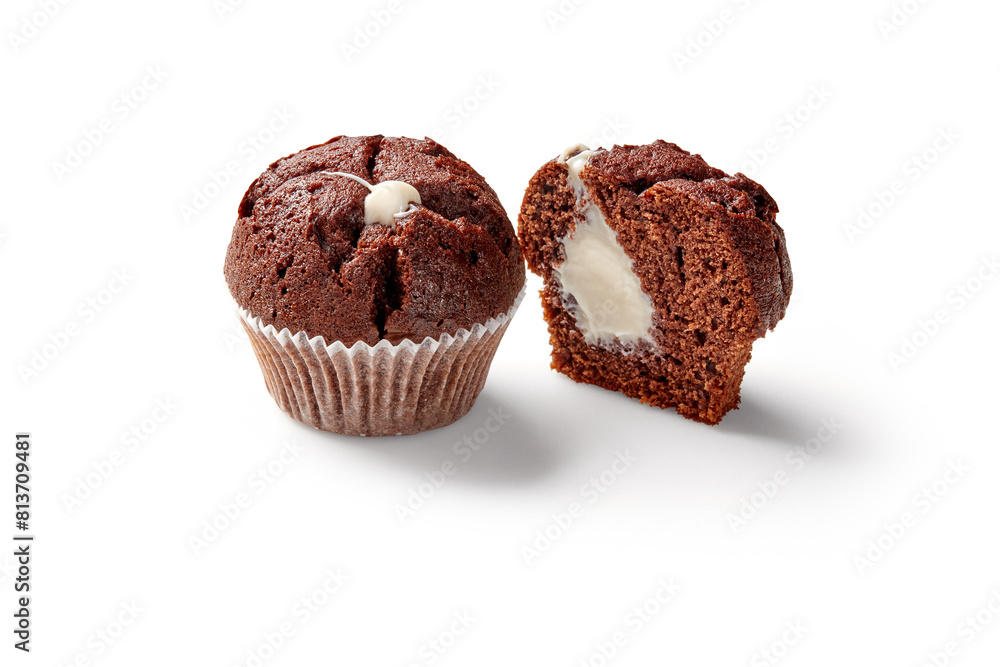 Whole and sliced chocolate muffins with creamy filling Whole and sliced chocolate muffins with creamy filling