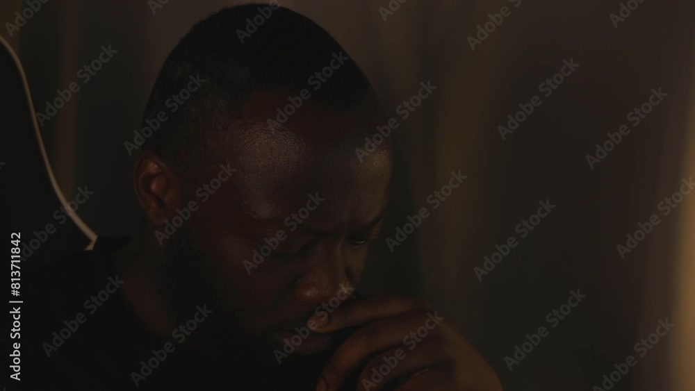 Black Male Thinking Intensely By Himself In Room