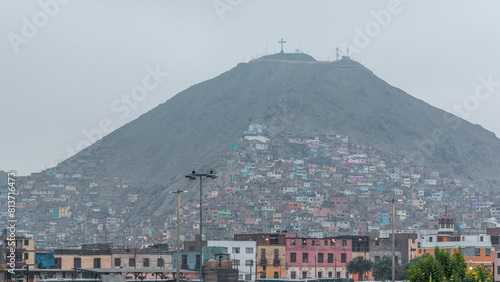 Slums on the slope of hill San Cristobal on the northern side of the river Rimac day to night timelapse. Lima, Peru photo