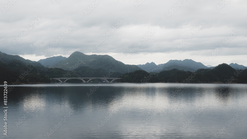Tranquil Lake Scene with Mountains and Bridge