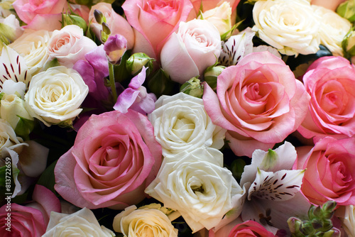 Beautiful floral background of white and pink roses. Photo of a bouquet in a flower shop © Oksana