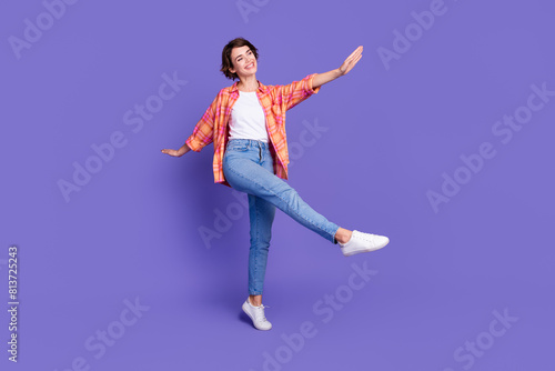 Full size photo of nice young girl enjoy dancing wear shirt isolated on violet color background © deagreez