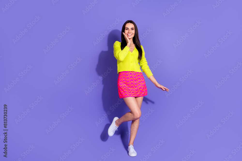 Photo of glad cute cheerful girl wear stylish clothes empty space isolated on purple color background Photo of glad cute cheerful girl wear stylish clothes empty space isolated on purple color background