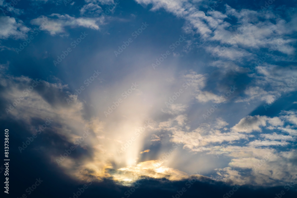 Obraz premium Background with a dramatic sky and sun rays from behind the clouds.