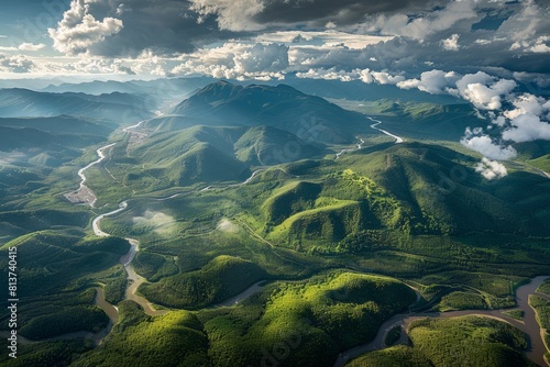 Aerial view showcasing a lush green valley with a winding river flowing through it