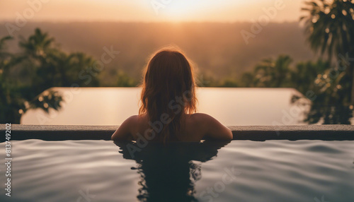 Portrait of woman in infinity pool in Bali  sunset view 