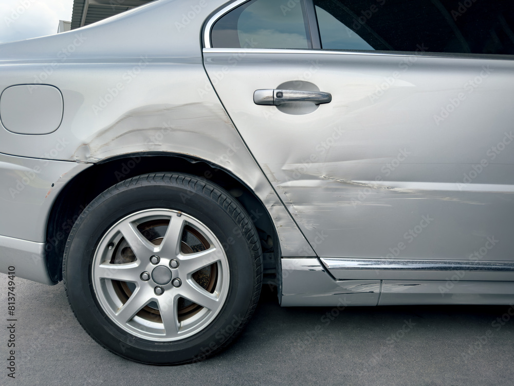 car body damage after accident, scratch and dent on body of modern car at car park car body damage after accident, scratch and dent on body of modern car at car park