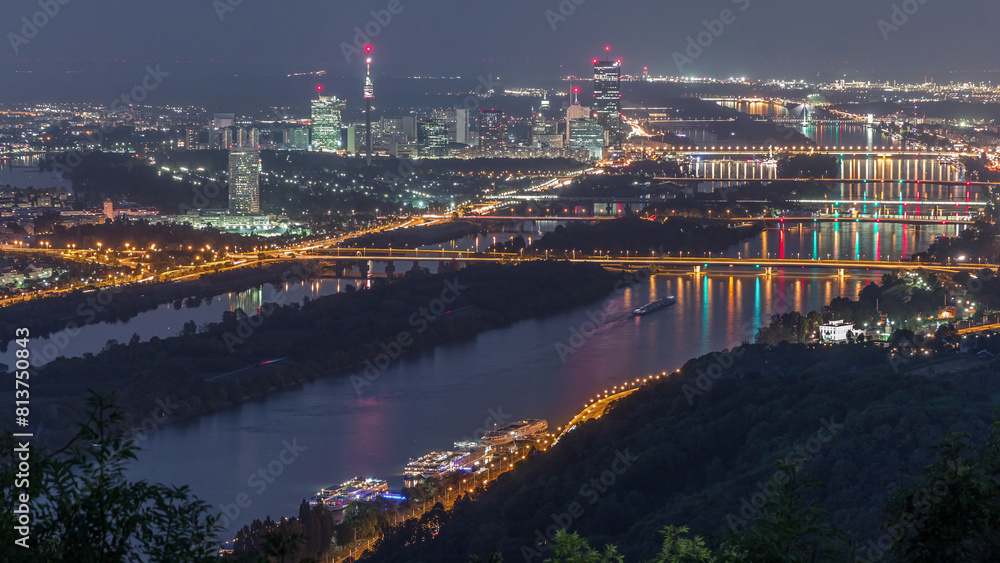 Fototapeta premium Skyline of Vienna from Danube Viewpoint Leopoldsberg aerial night timelapse.