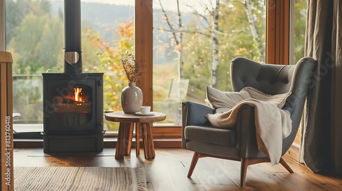 A cozy Scandinavian-style living room with an armchair fireplace and wooden table in front of the window 