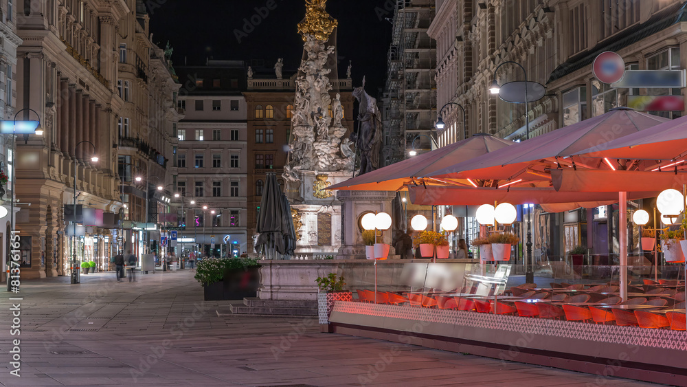 Obraz premium People is walking in Graben St. night timelapse, old town main street of Vienna, Austria.